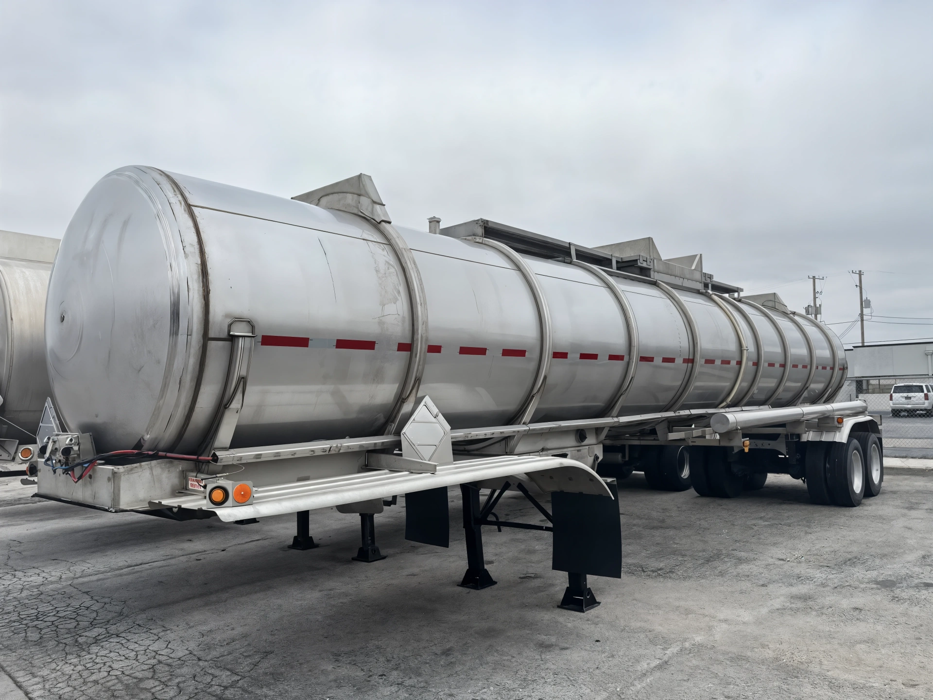 Stainless-steel chemical tanker trailer in yard