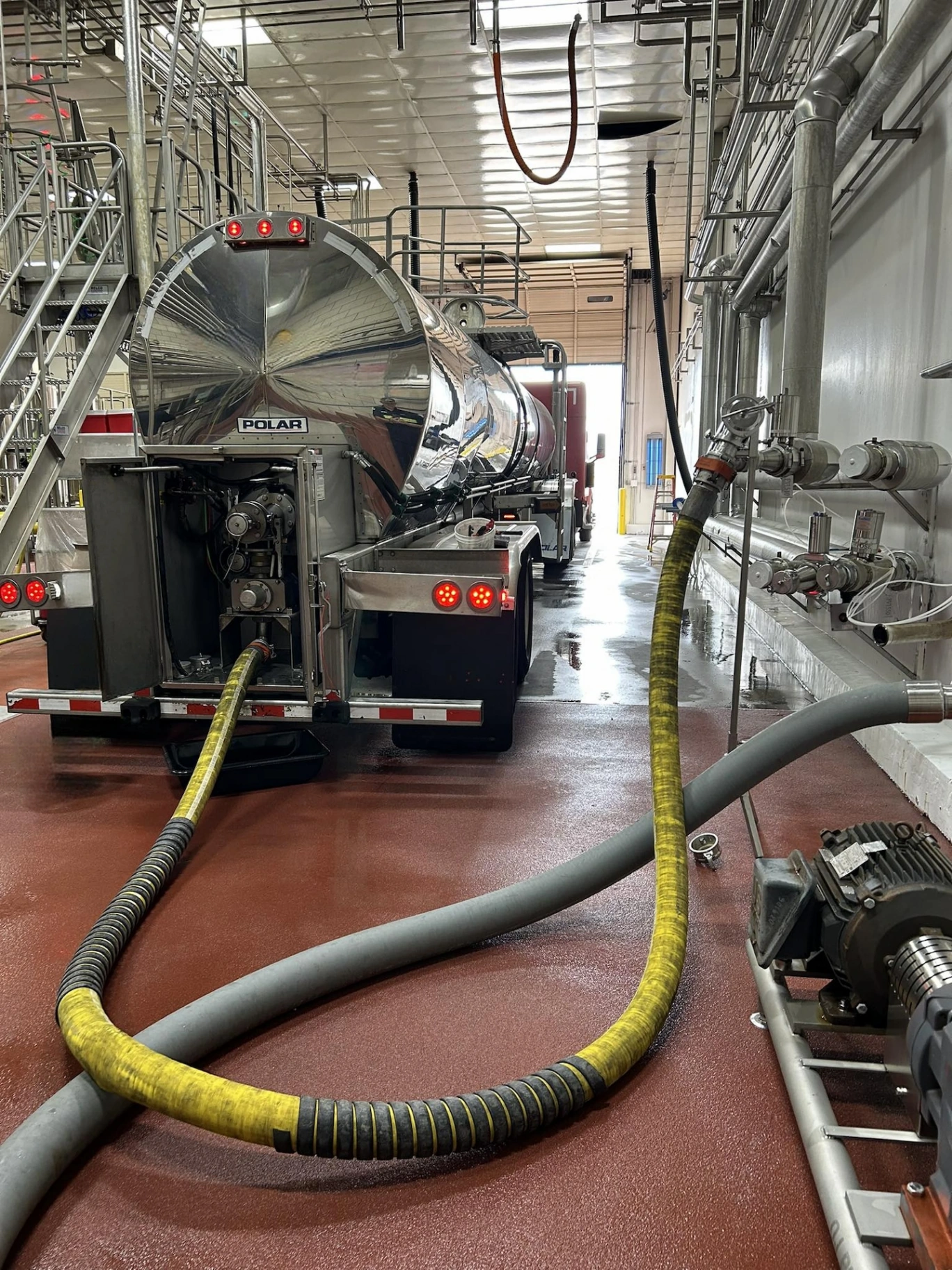 Polar food-grade tanker offloading inside a beverage production facility